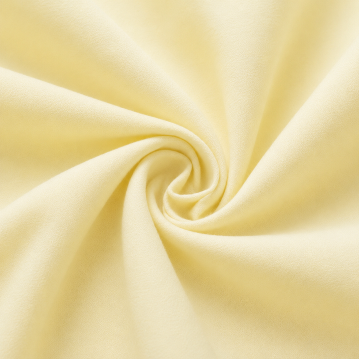 Lemon-yellow cotton fabric arranged in soft folds