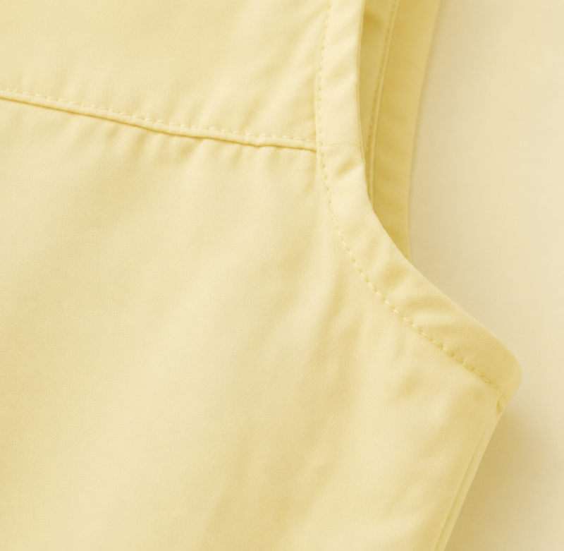 Close-up of the yellow dress armhole and bodice seam
