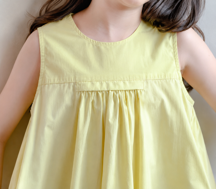 Front bodice detail showing the round neckline and gathers on the yellow dress