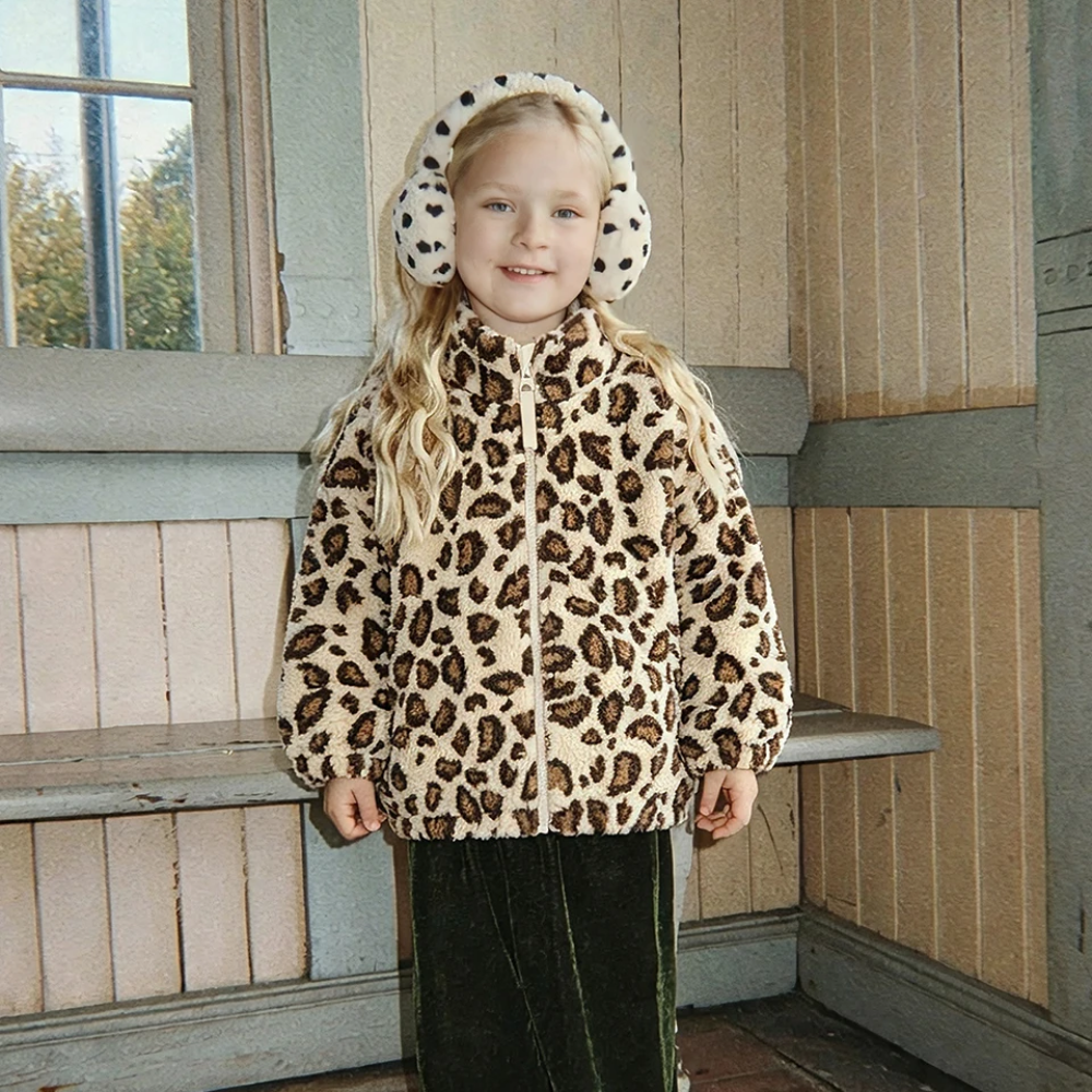Child wearing a leopard-print zip-up fleece jacket and earmuffs