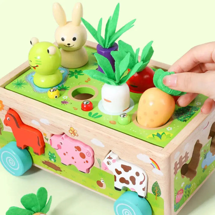 Hand lifting a vegetable piece from the top of a wooden farm shape sorter