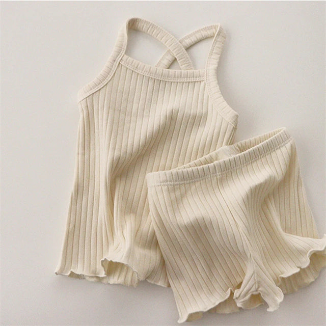 Light beige cotton pajama set with a sleeveless cross-back tank and matching shorts