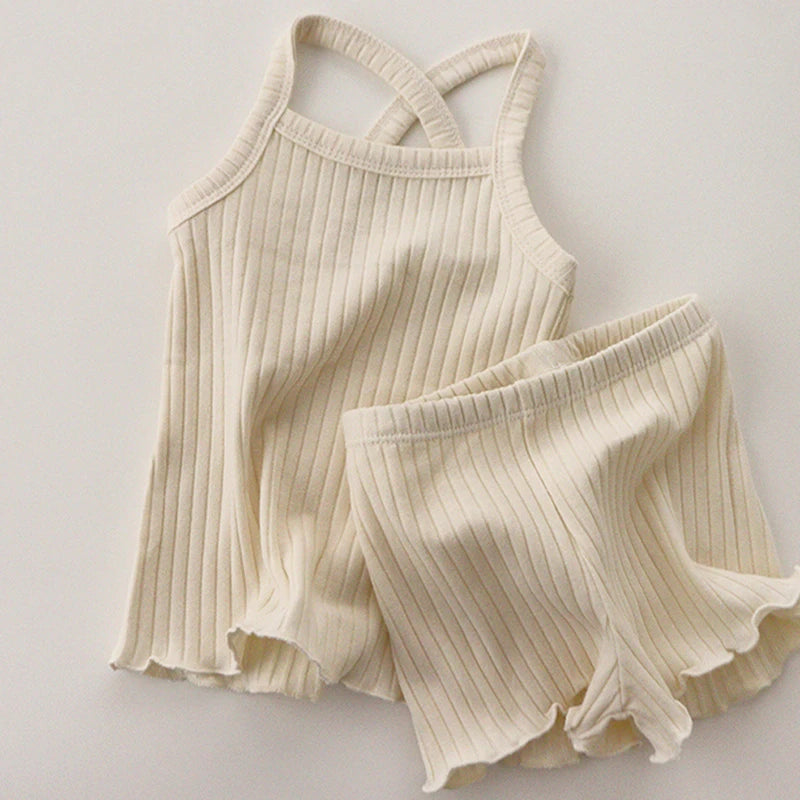 Light beige ribbed pajama tank and shorts with wavy hems and an elastic waistband