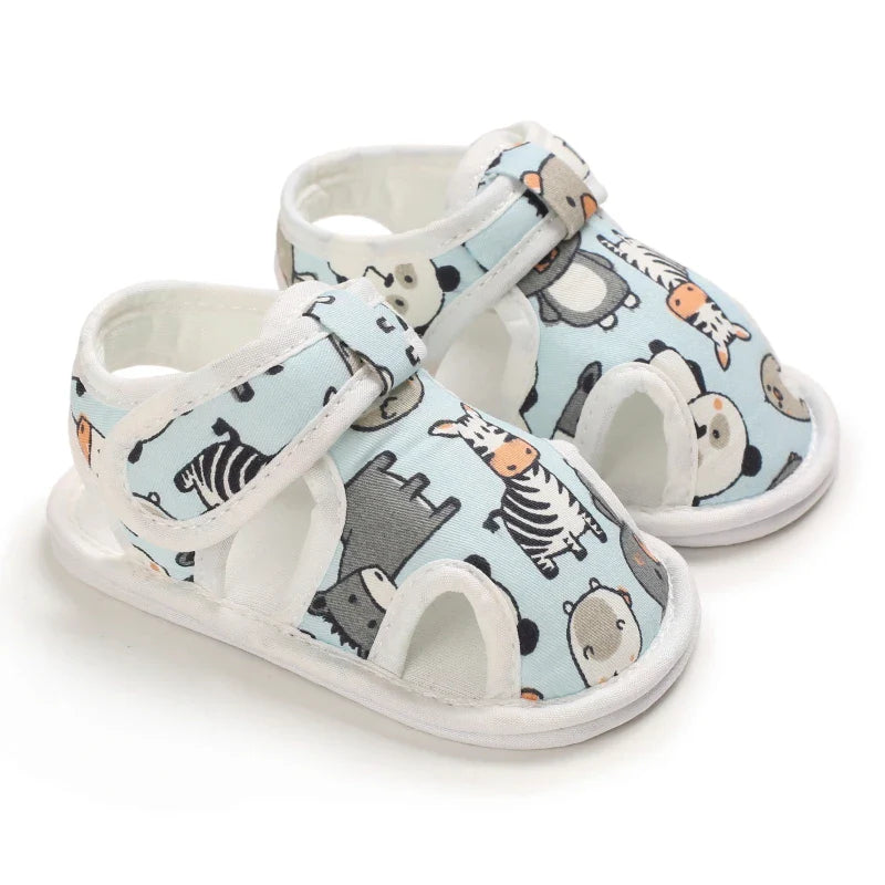 Pair of light blue baby sandals with animal prints, white trim and ankle straps