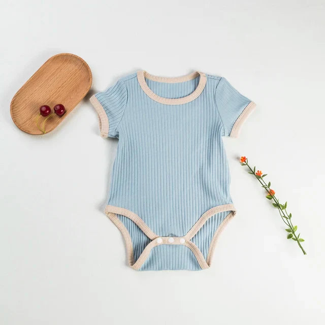 Light blue short-sleeve baby romper with cream trim and bottom snaps
