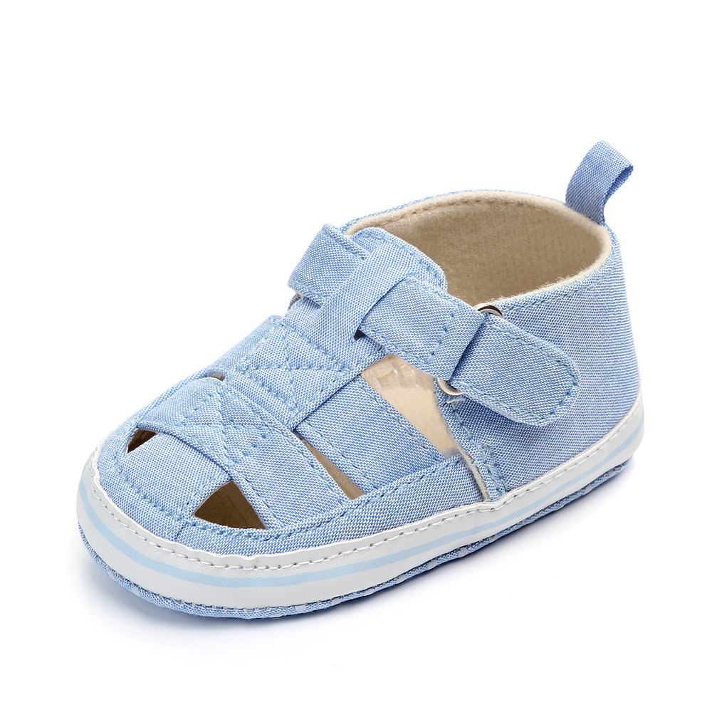 Light blue baby sandal with an ankle strap and white sole