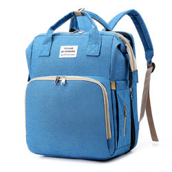 Light blue diaper backpack with front zip pocket, top handles and shoulder straps