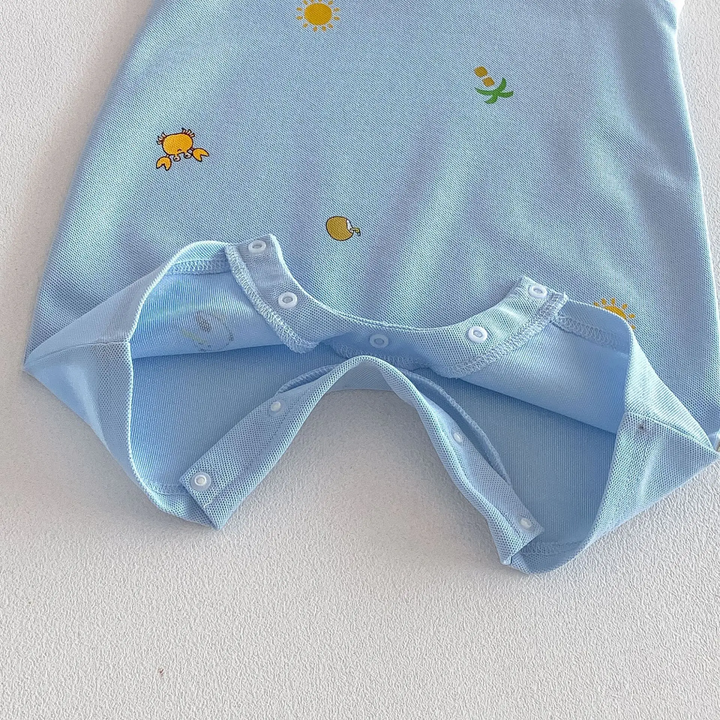 Unfastened bottom snaps on a light blue printed baby romper, showing the diaper-change opening