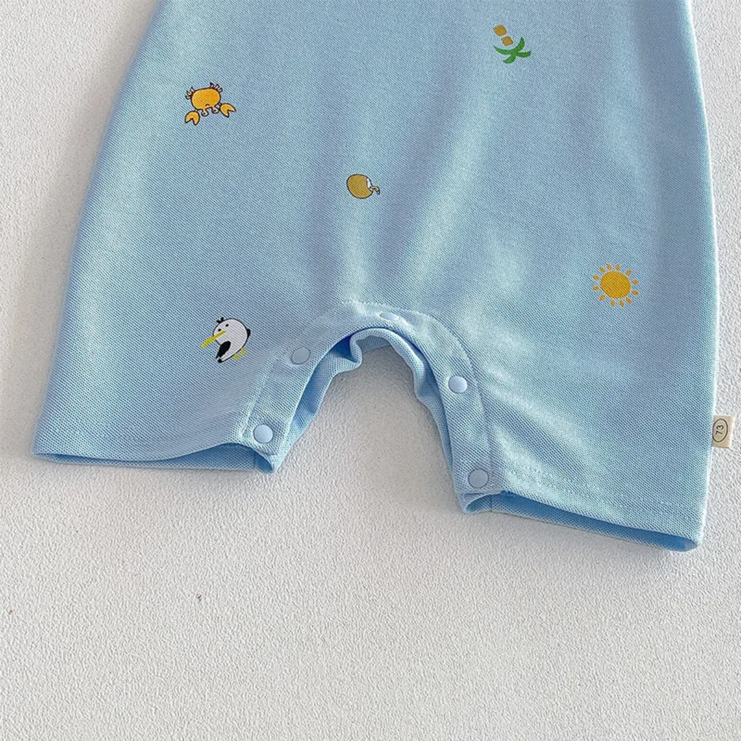 Short legs and bottom snap placket on a light blue printed baby romper