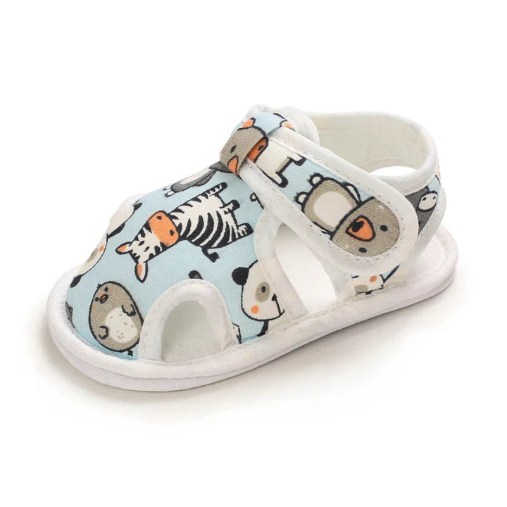 Side view of a light blue animal-print baby sandal with open cutouts