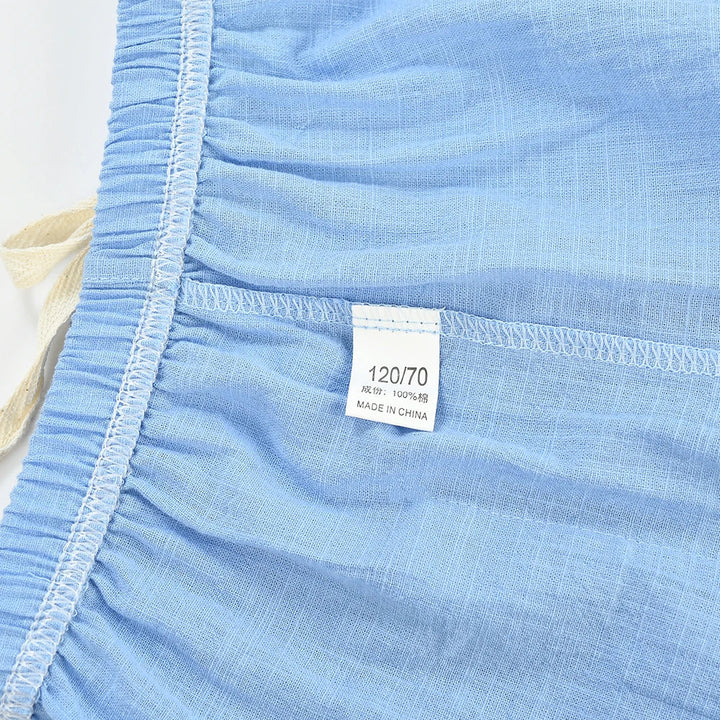 Inside waistband and seam stitching of light blue kids&