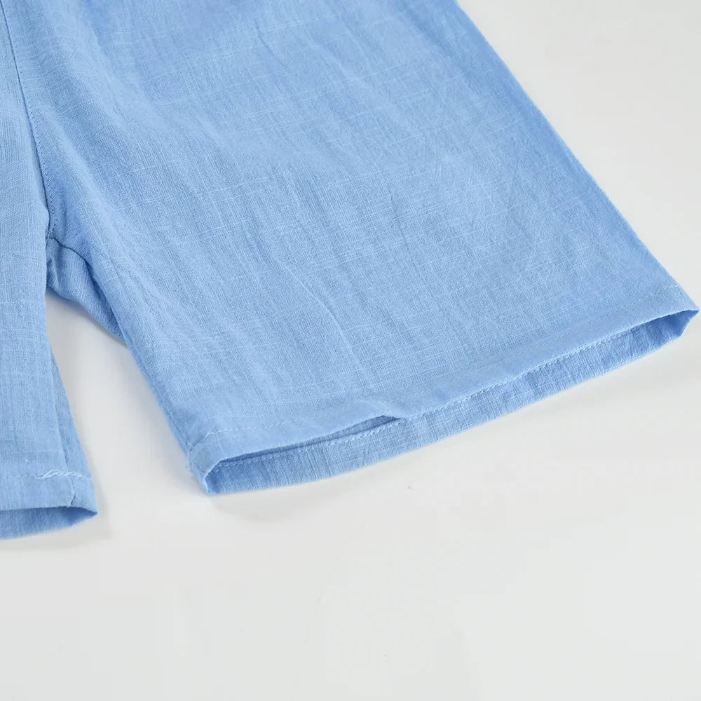 Close-up of the straight leg opening and stitched hem on light blue shorts