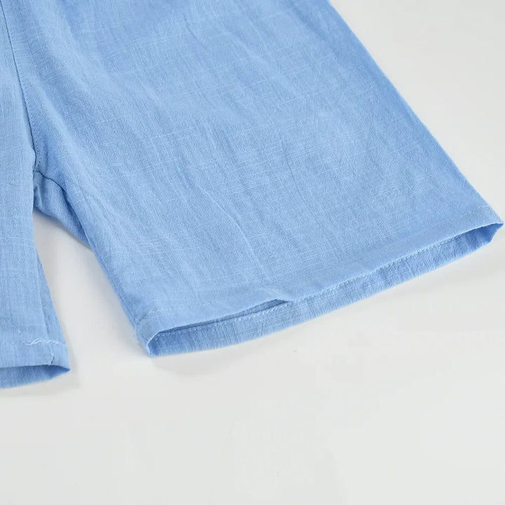 Close-up of the straight leg opening and stitched hem on light blue shorts