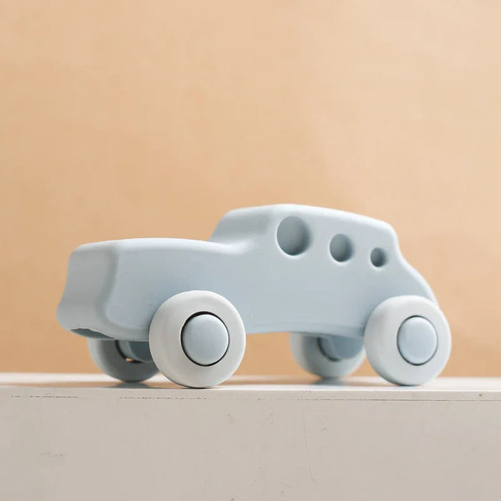 Light blue silicone toy car with pale wheels and three round window openings