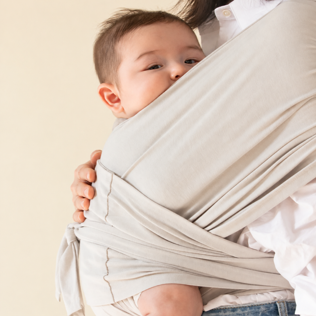 Close view of a baby resting against a parent&