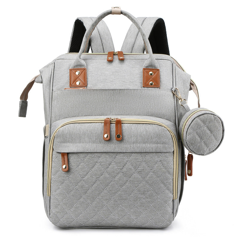 Light gray diaper backpack with quilted front storage and a matching round side pouch