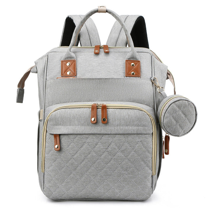 Light gray diaper backpack with quilted front storage and a matching round side pouch