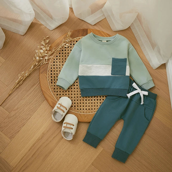 Light green colorblock sweatshirt with blue-green joggers and a white drawstring