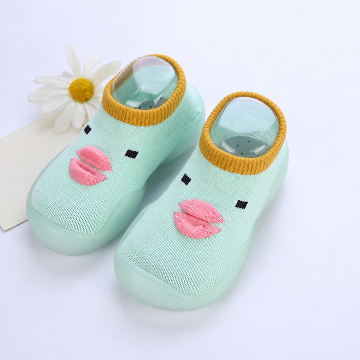 Light green duck-face sock shoes with pink beaks and mustard-colored cuffs