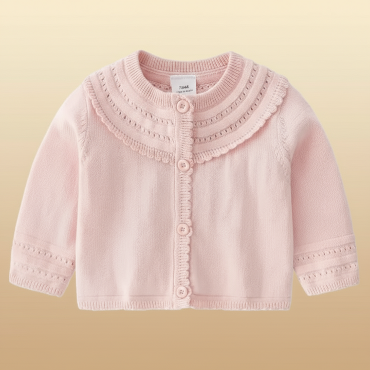 Light pink baby cardigan with decorative neckline bands and patterned sleeve cuffs