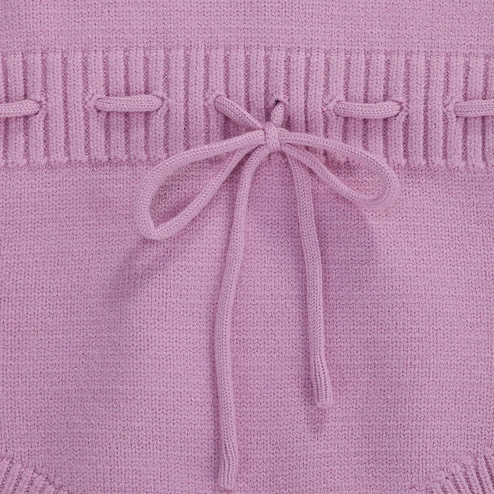 Light purple romper waist with textured knit detailing and a tied bow