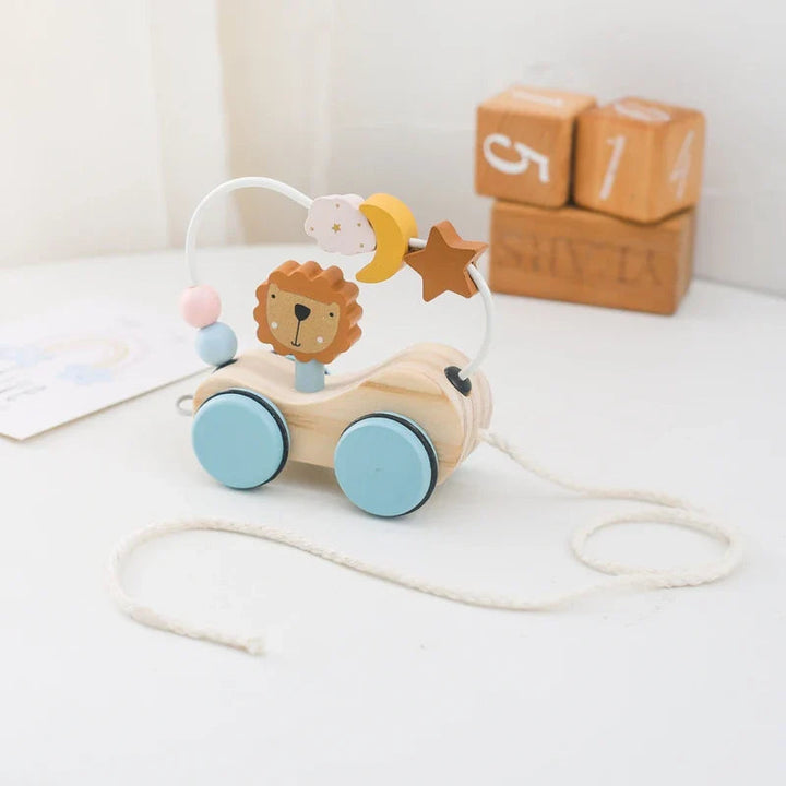 Wooden bead maze car with a lion, moon and star shapes, blue wheels, and a pull cord