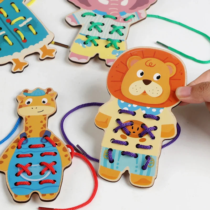 Close-up of lion and giraffe lacing boards threaded with purple, red, and blue cords