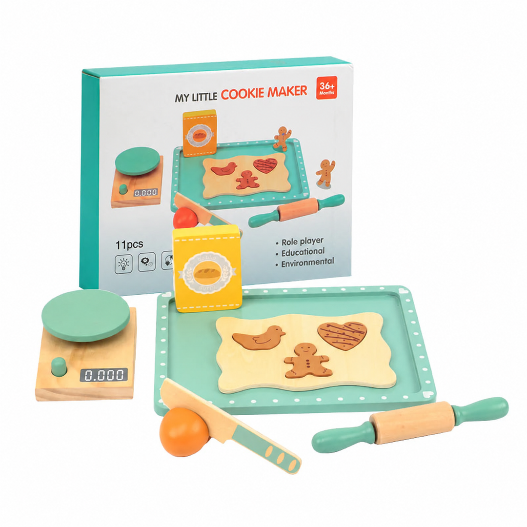 Wooden pretend baking set with mint-green tray, rolling pin, play scale and cookie pieces beside its box