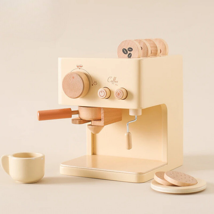 Beige wooden espresso machine with a coffee handle, cup, saucer, pretend cookies, and coffee discs.