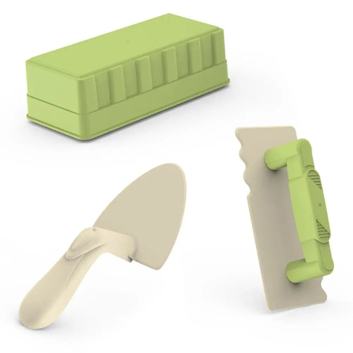 Green brick mold, cream trowel, and handled spatula from the three-piece sand toy set