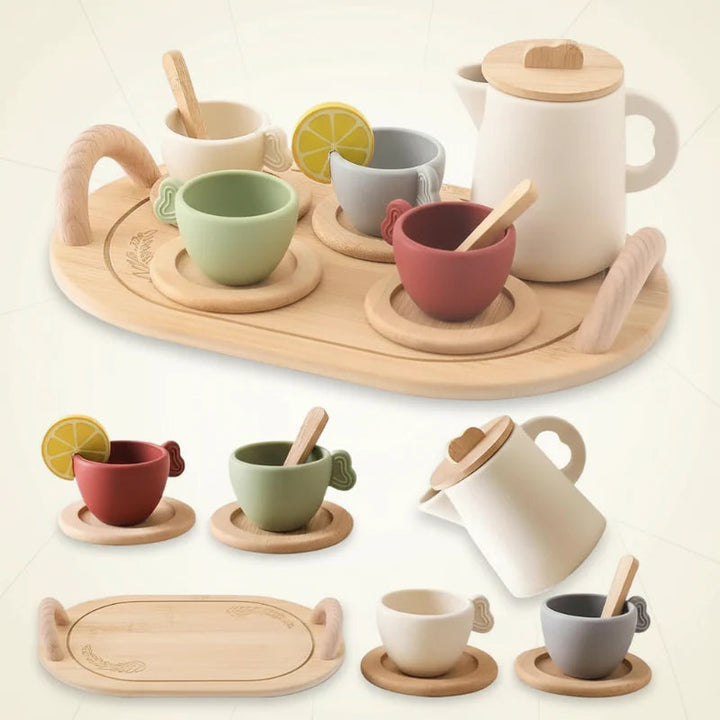 Tea set shown with a wooden tray, colorful cups, saucers, spoons, and a cream-colored pitcher