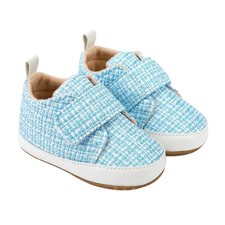 Blue baby shoes with textured uppers, wide hook-and-loop straps, and white sole edges