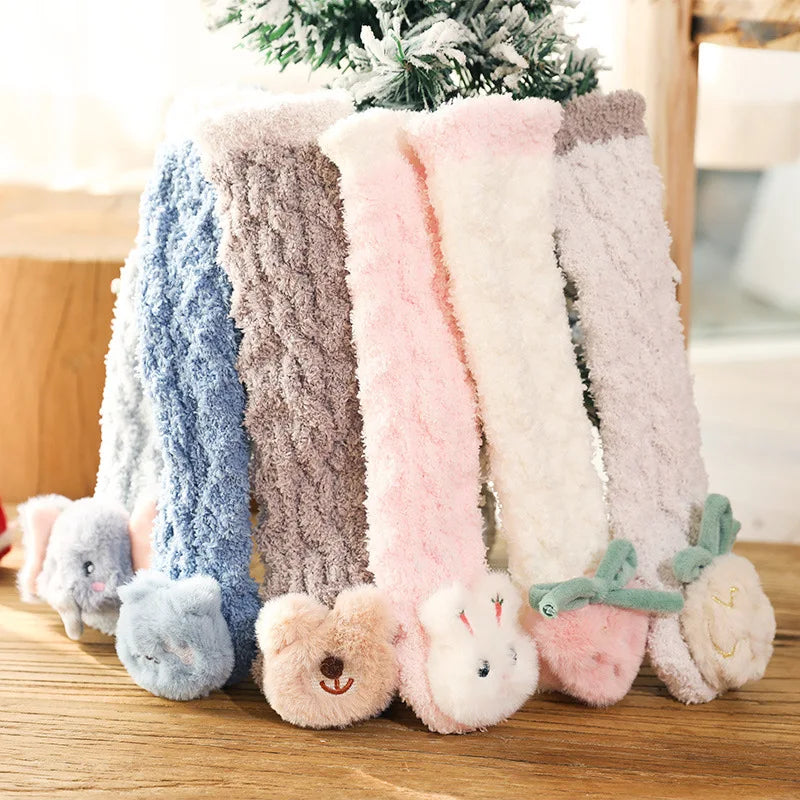 Long fluffy baby socks with animal and fruit details arranged upright in assorted colors.