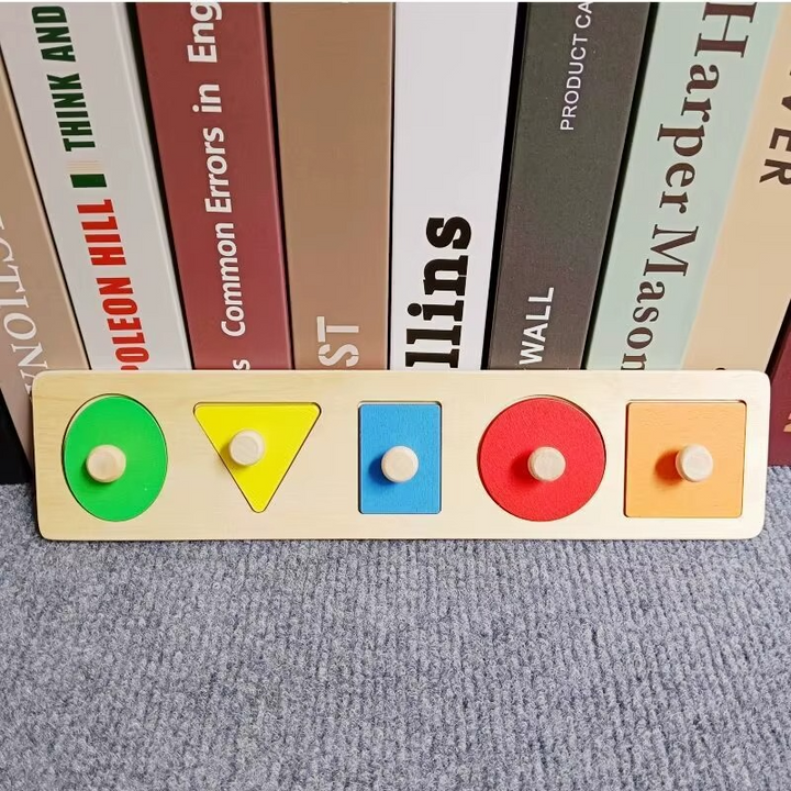 Long rectangular wooden peg puzzle with five colorful geometric pieces