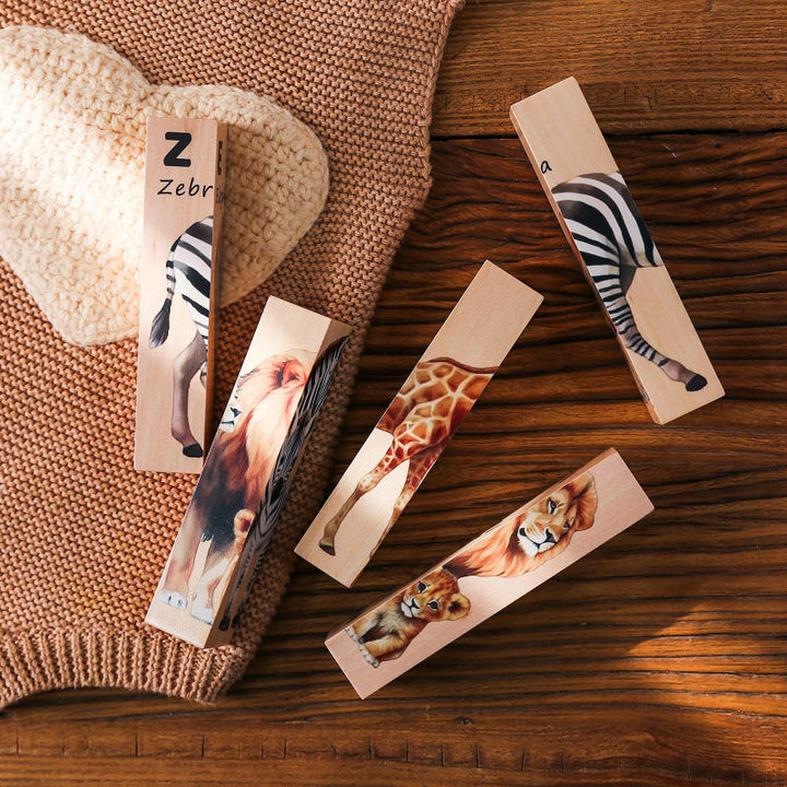 Loose wooden puzzle blocks showing parts of zebra, giraffe, and lion illustrations on a table