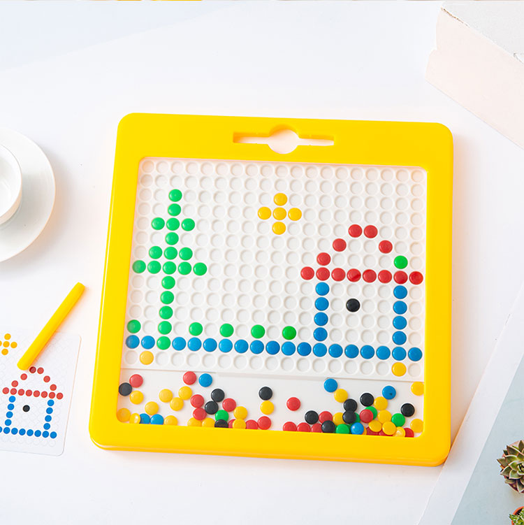 Magnetic bead drawing board showing a tree, house, and sun pattern