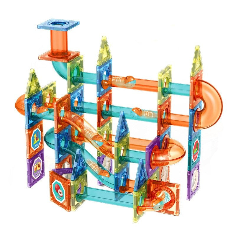 Assembled magnetic marble run with tall tile towers, straight channels and orange curved track pieces.