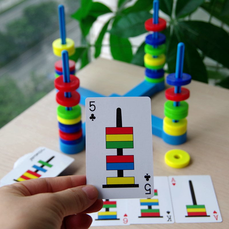 Pattern card held in front of magnetic rings arranged on four blue posts