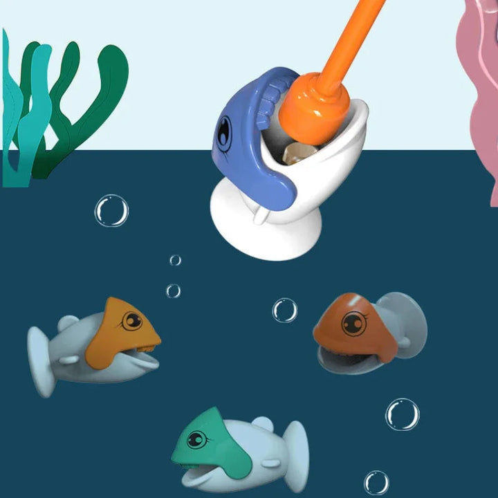 Close-up of an orange magnetic fishing tip lifting a blue fish beside other colorful fish.