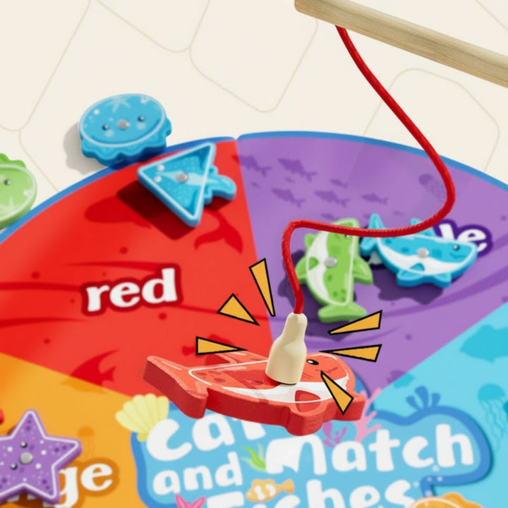 Magnetic rod lifting a red wooden fish from the color-matching mat