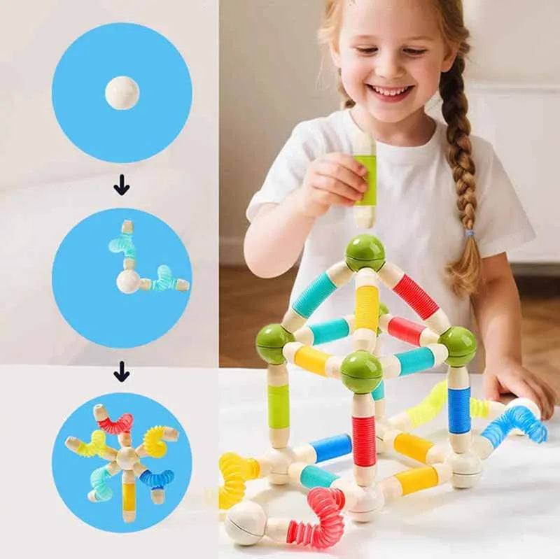Girl assembling a colorful magnetic structure beside a connection diagram