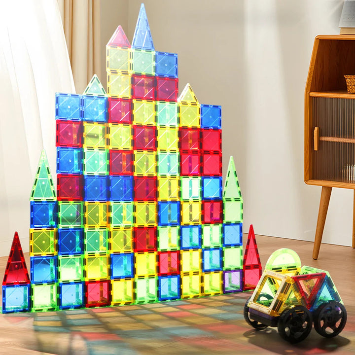 Tall multicolored magnetic tile building with a small wheeled model beside it