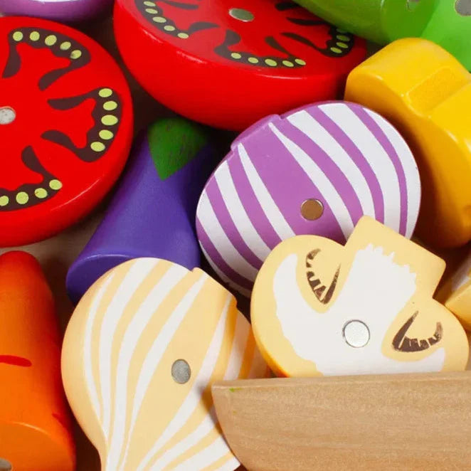 Close-up of wooden onion, tomato, and mushroom pieces with visible magnetic connectors