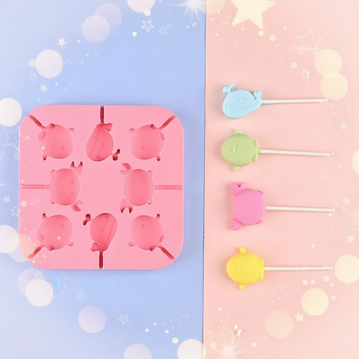 Pink marine-animal lollipop mold beside four pastel sea-creature treats