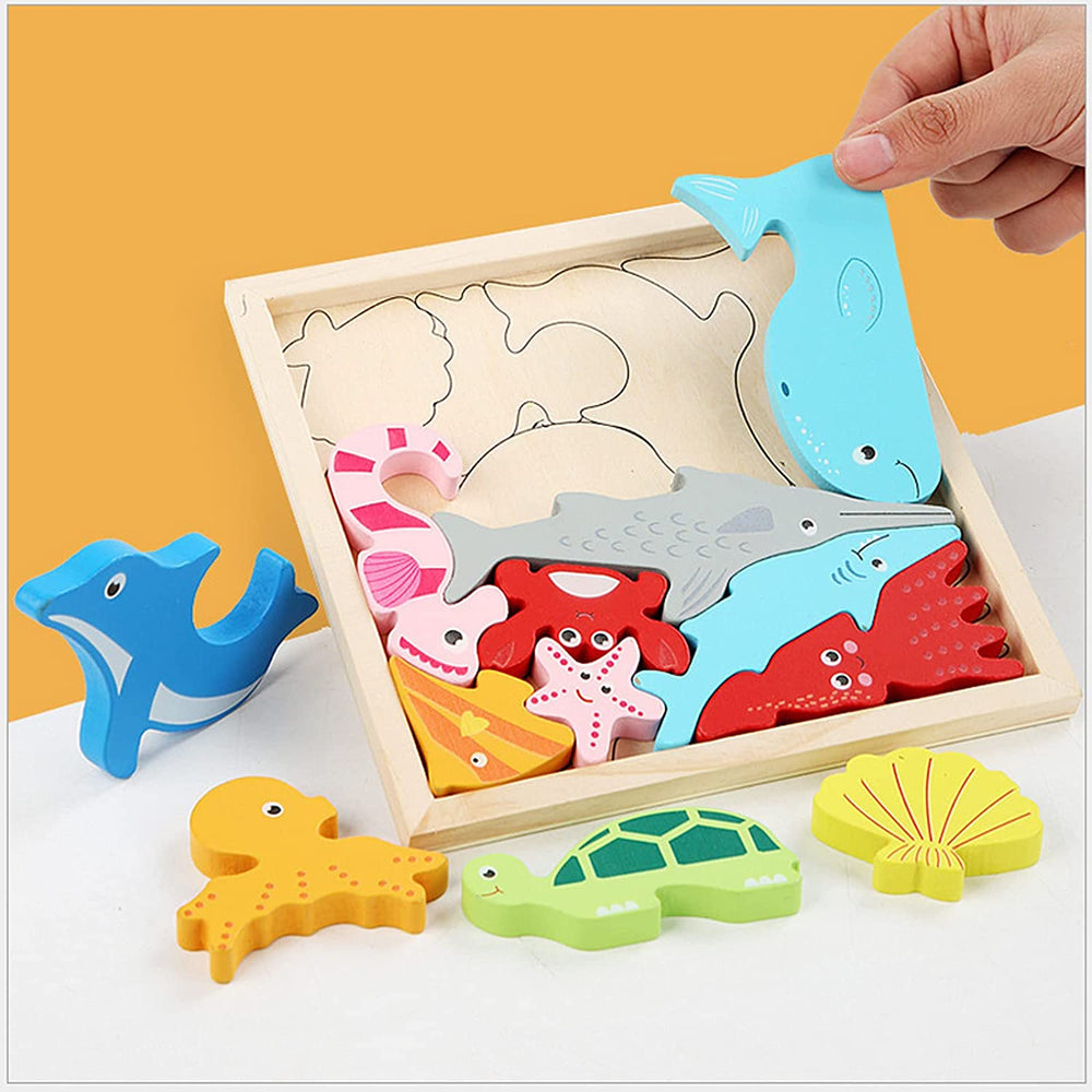 Hand lifting a sea animal piece from a wooden marine-themed puzzle