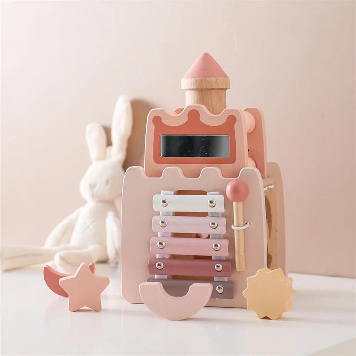 Castle-shaped wooden music tower with pastel metal bars, a side mallet, and shape-sorting pieces