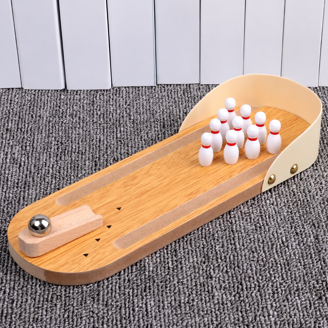 Wooden bowling game on a gray surface with pins set up and a metal ball ready to roll