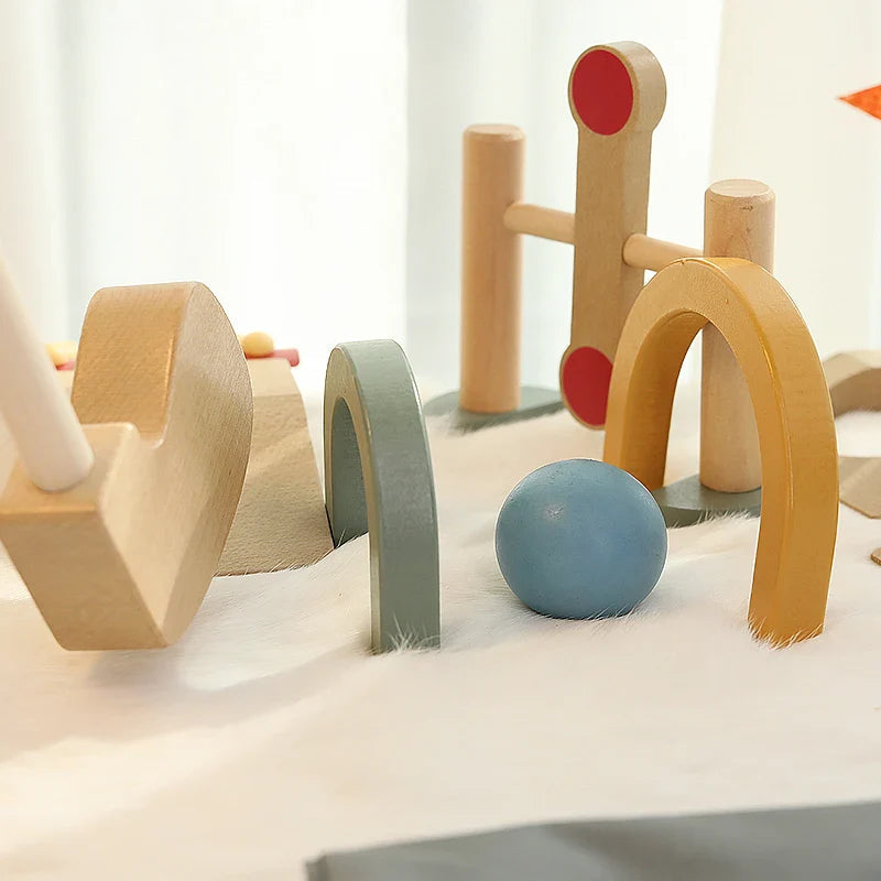 Blue golf ball beside yellow and green wooden arches and an upright course obstacle