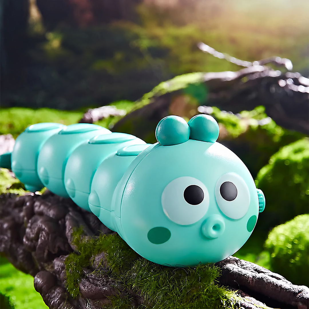 Mint green caterpillar toy with large eyes on a mossy branch