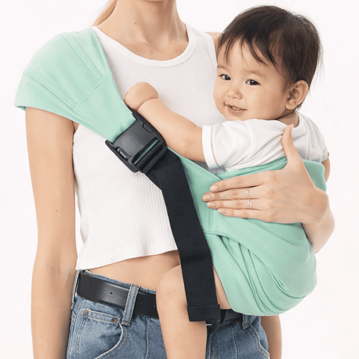 Close-up of a mint-green hip carrier worn across an adult&